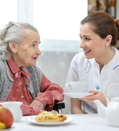 hcss volunteer having tea with senior