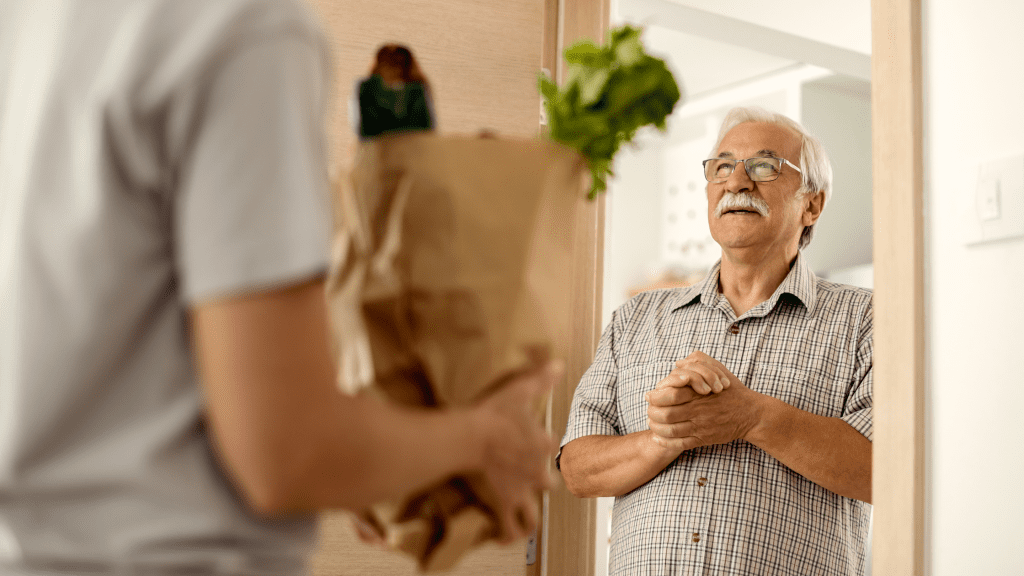 Senior man receiving food delivery